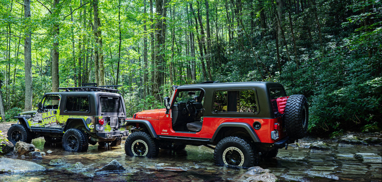 2 Jeeps driving through creek on trail