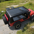 Red off-road Jeep with black roof rack on a rocky path