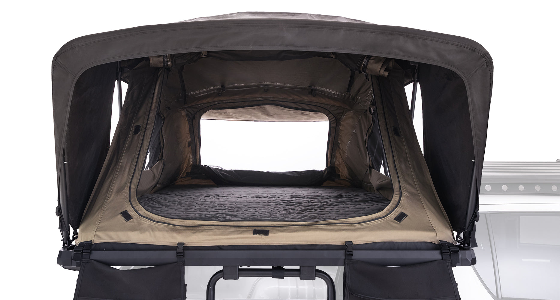 Roof top tent with black and beige interior on a white background