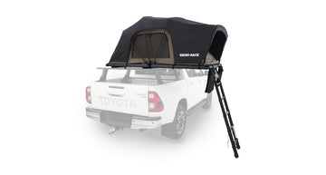 Black truck bed tent attached to a white Toyota truck on a white background