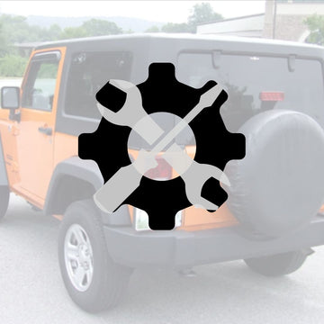 Gear and tools in front of a jeep